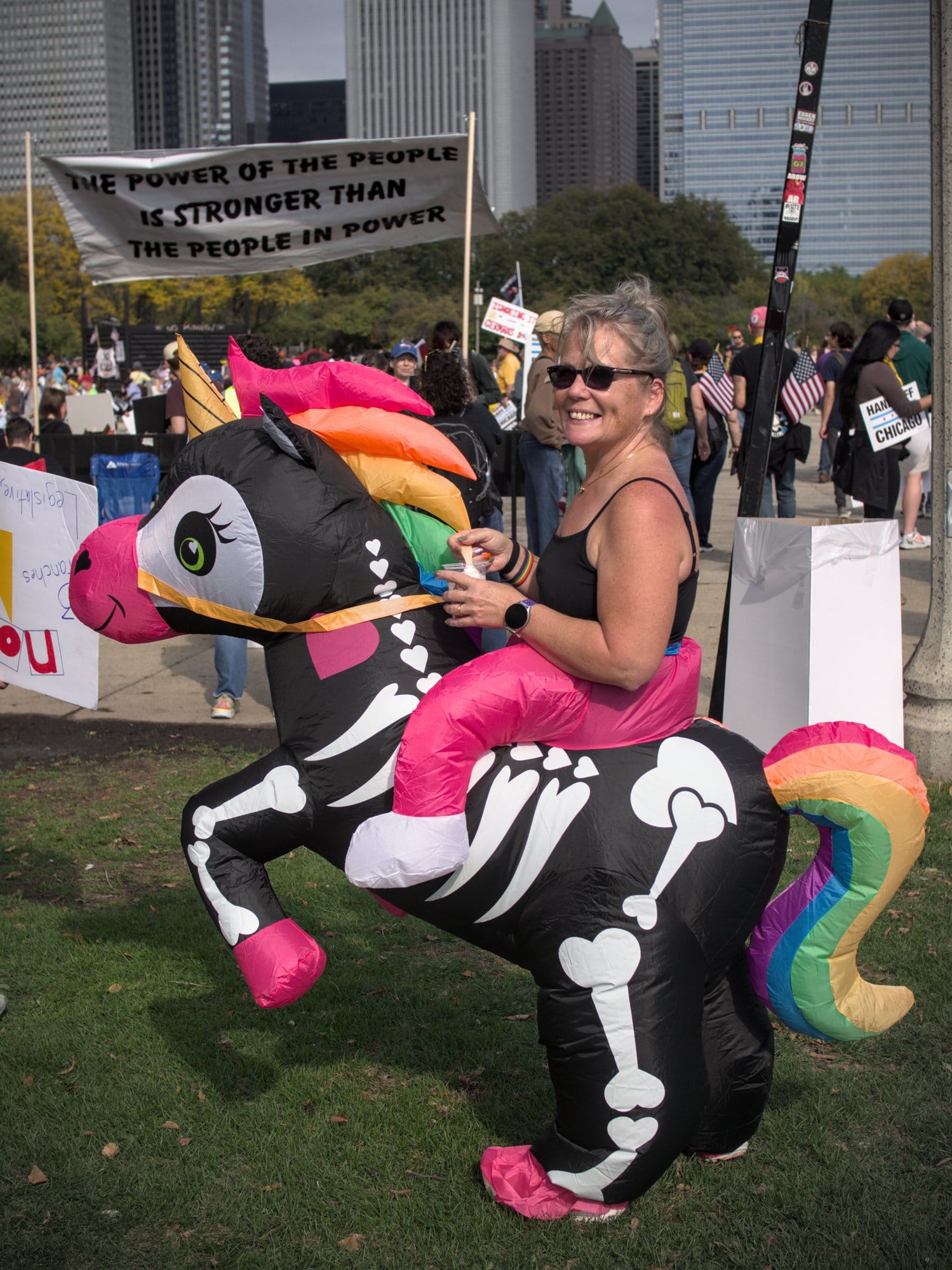  Robin Erickson shows off an inflatable skeletal rainbow unicorn rider costume at the No Kings rally in Chicago.  (Piper Bly)  
